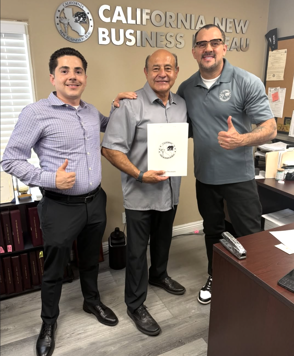 Christian Vasquez at the Santa Ana office with two clients